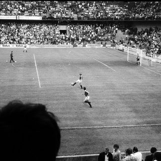 Classic black-and-white soccer match in stadium.