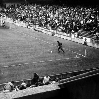 Classic soccer match with player kicking ball.