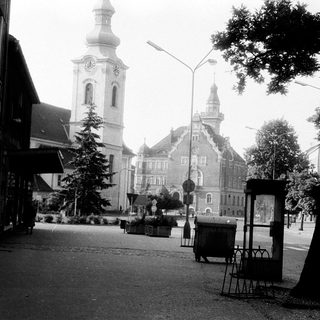 Historic European town square with church tower.