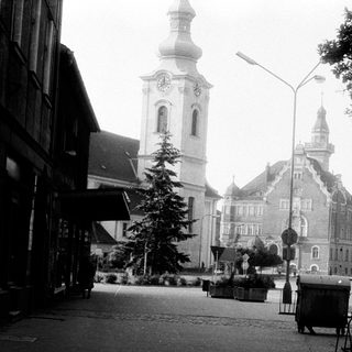 Historic European town square with church tower.