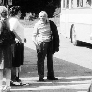 People boarding a bus labeled "Zajezo" in a bus station.