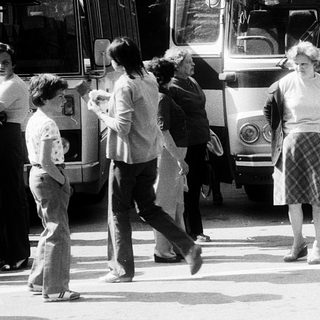 People boarding a bus labeled "Zajezo" in a bus station.