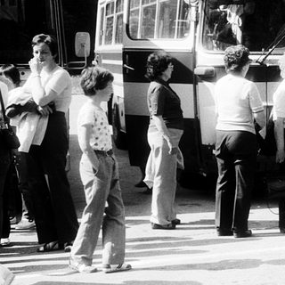 People boarding old-style buses labeled "Zajezd" in queue.