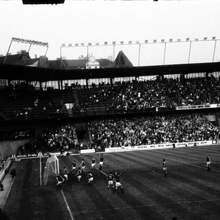 Historic soccer match with packed stadium.