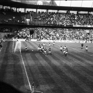 Classic soccer match with packed stadium.