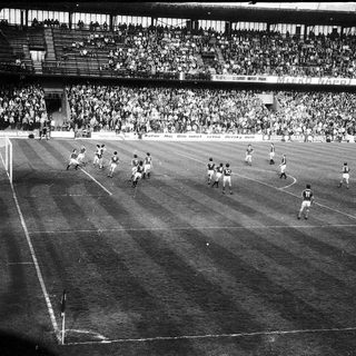 Classic soccer match with packed stadium.
