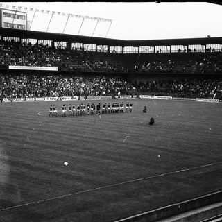 Football match in large stadium.
