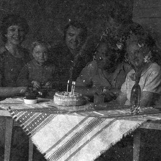 Birthday celebration with cake and lit candles.