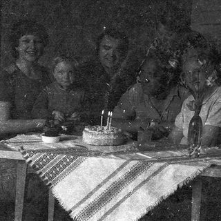 Birthday celebration with cake and lit candles.