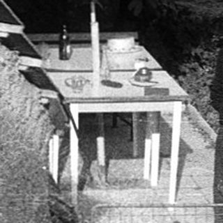 People relaxing in a backyard courtyard with benches.