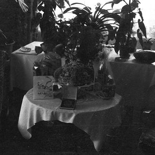 Vintage indoor table with greenery, candles, and vintage decor.