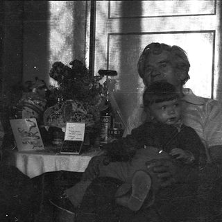 Vintage photo of man reading by window.