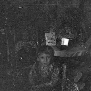 Blurred nighttime scene with illuminated laptop screens.
