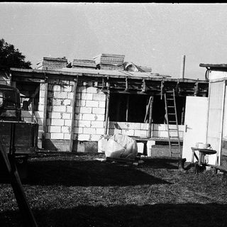Mobile home under partial construction with exposed brick walls.