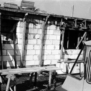 Damaged concrete structure with exposed rebar.
