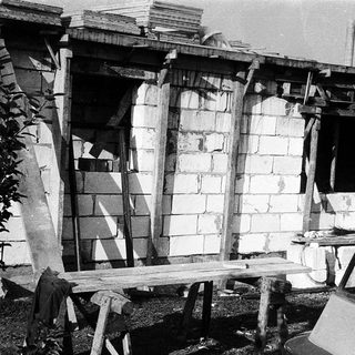Damaged concrete structure with exposed rebar.