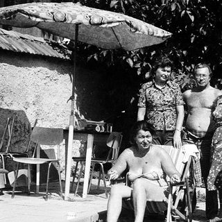 Family gathering outdoors in summer attire.