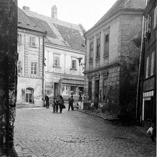 Historic cobblestone street with old European architecture.