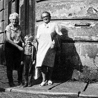 Historic European street scene with family near old buildings.