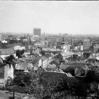 Historic cityscape with dense architecture and early 20th-century buildings.