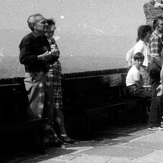 People playing with bubbles outdoors near historic stone steps.