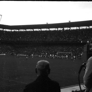 Black-and-white stadium view of soccer match.