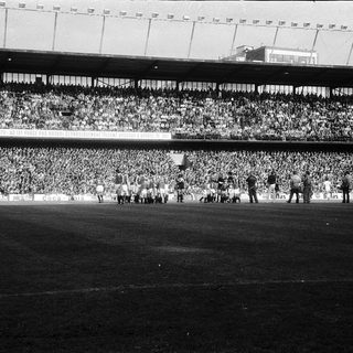 Massive stadium crowd during a football match.