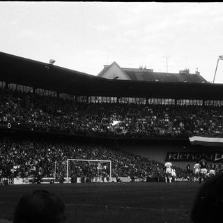 Historic stadium match with packed crowd.