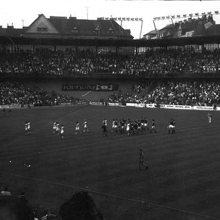 Historic soccer match with large stadium crowd.