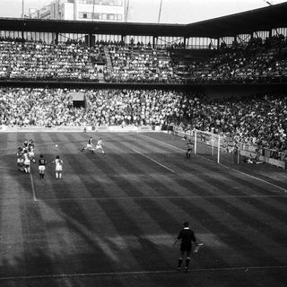 Classic soccer match with packed stadium.
