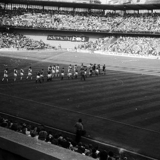 Pre-match team warm-up on soccer field.
