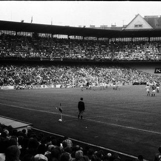 Classic football match at packed stadium.