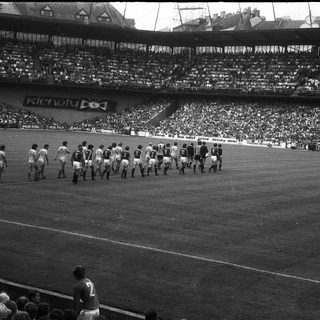 Pre-match team walkout on football pitch.