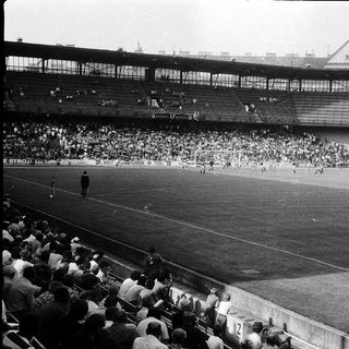 Black-and-white stadium photo of a soccer match.