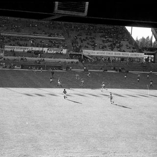 Black-and-white soccer match in stadium.