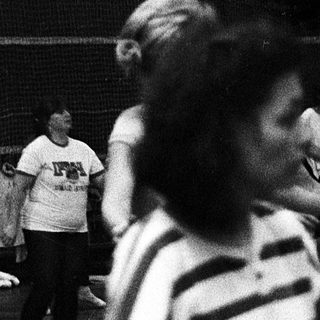 Children dancing indoors during a gym class.