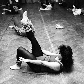 Dance class in progress with floor exercises.