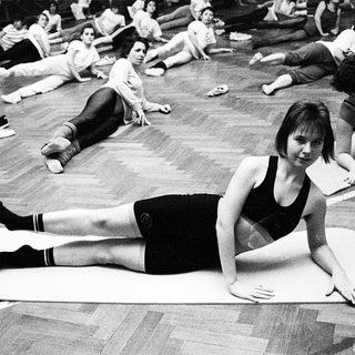 Group yoga or stretching session in gym.