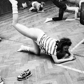 People participating in a floor exercise routine.