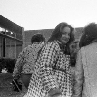 Group of people outdoors in casual 1970s attire.