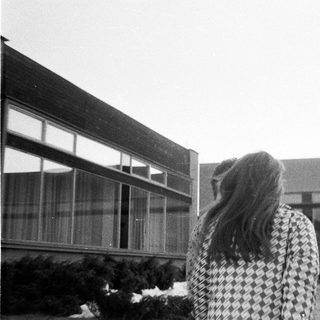 People walking outside school building.