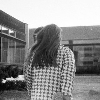 People walking outside school building.