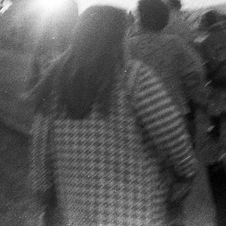People walking outdoors during sunset or sunrise.