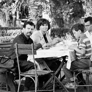 People dining outdoors at a café table.