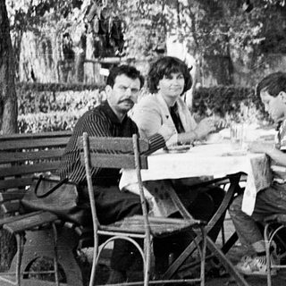 People dining outdoors at a café table.