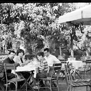 People dining outdoors at a café table.