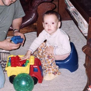 Man and young child playing with toys indoors.