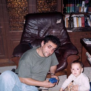 Man and young child playing with toys indoors.