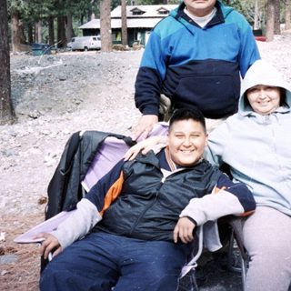 Family hiking in mountainous forested area.
