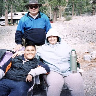 Family hiking in mountainous forested area.